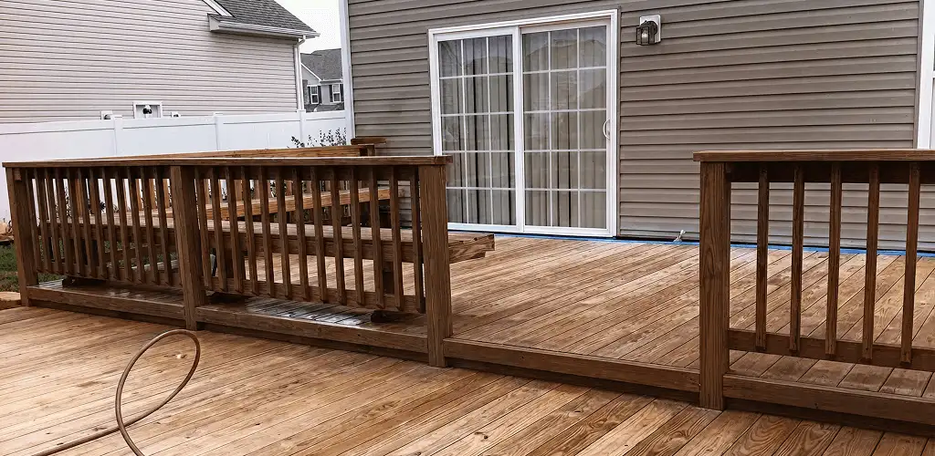 Deck sealing service protecting a backyard wood deck and railings in Wichita, KS