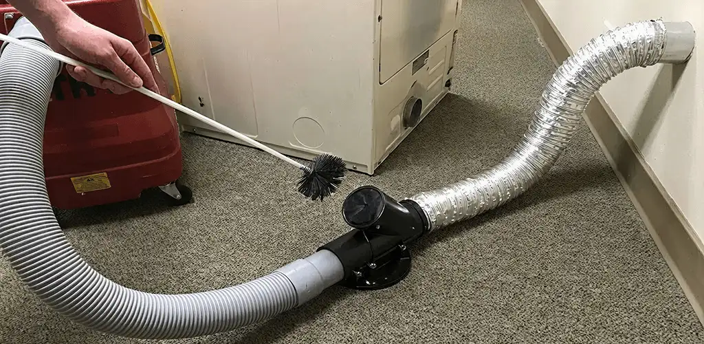 Dryer vent cleaning service removing lint from a dryer duct connection in Wichita, KS