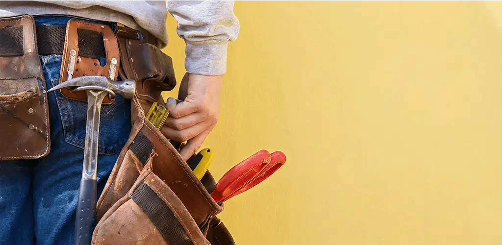 Handyman with tool belt ready for home repairs and maintenance in Wichita, KS