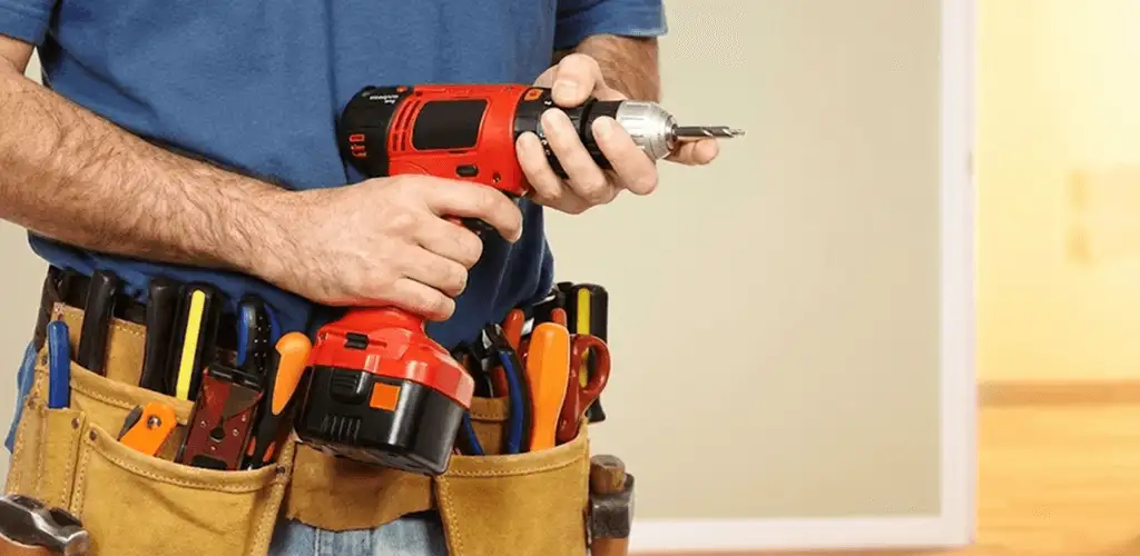 Handyman holding a power drill for home repairs and installations in Wichita, KS
