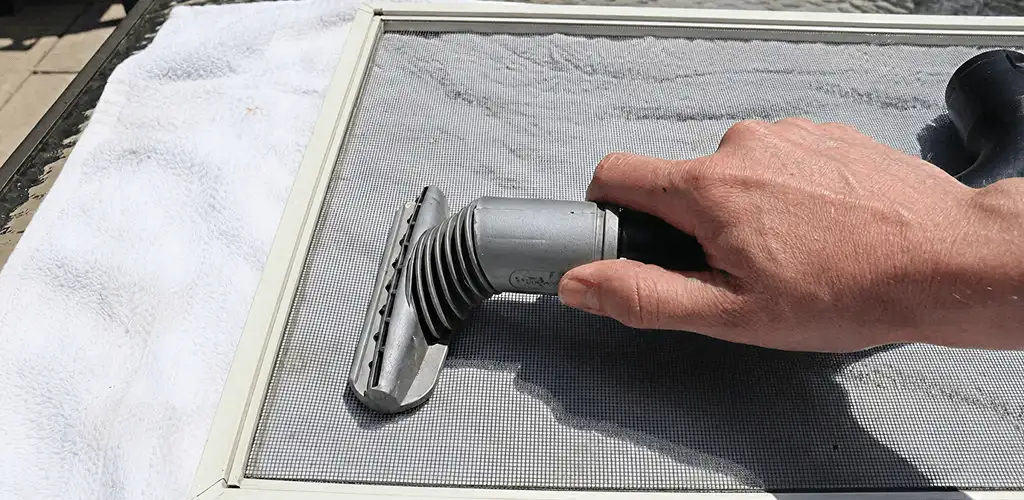 Window screen repair cleaning and fixing a damaged screen mesh in Wichita, KS